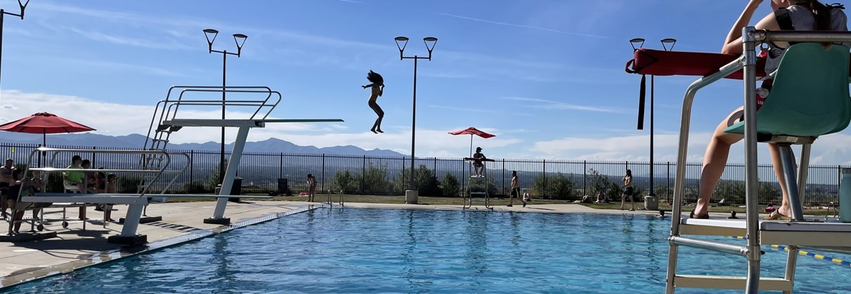 A person jumping into a pool.