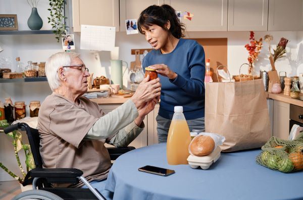 A woman and an old man eating.