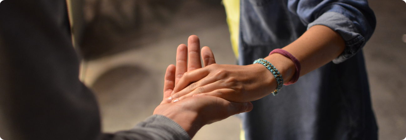A close-up of hands shaking.