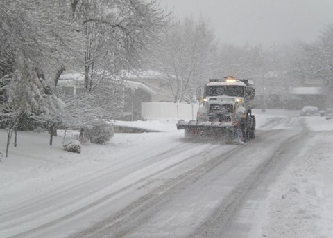 A truck driving on a snowy road.