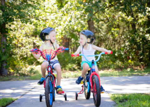 Two kids riding bikes.