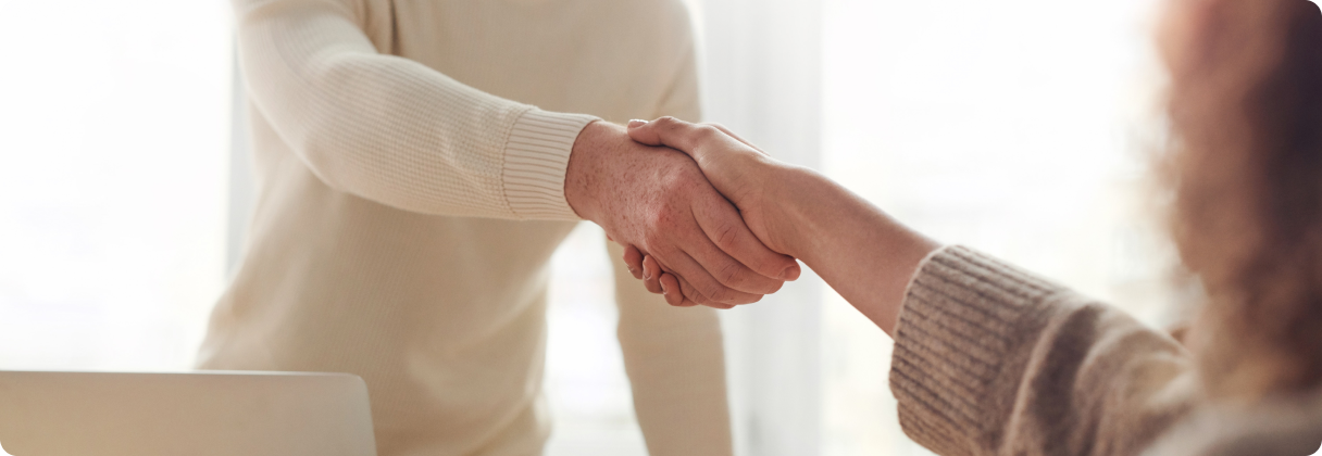 A close-up of a man shaking hands with a woman.