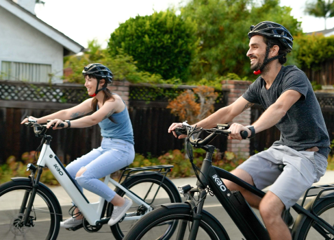 A man and a woman riding bikes.