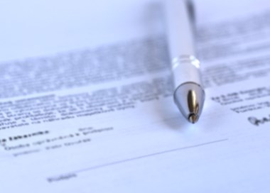 A close-up of a pen on a piece of paper.