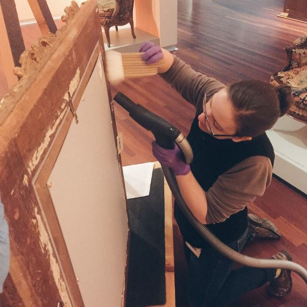 haynie uses a special hepa-filtered vacuum to perform routine cleaning on a painting removed from the european galleries