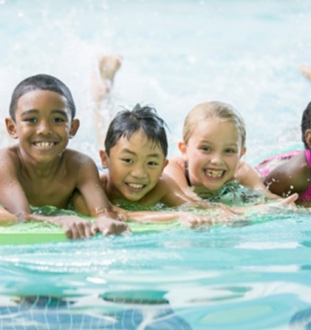 A group of kids in a swimming pool.