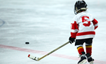 A kid playing hockey.