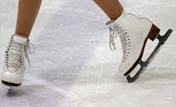 Figure skates on an ice rink.