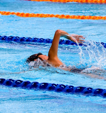A person swimming in a pool.