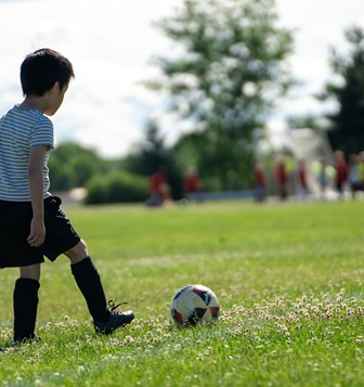 A boy playing football.