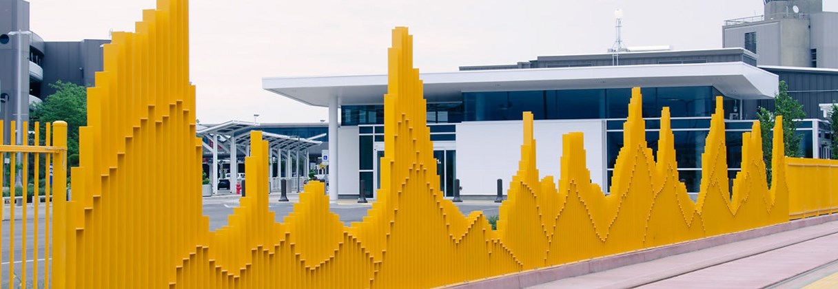 A building with a yellow fence.