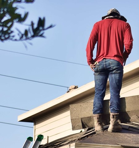 A person standing on a roof.
