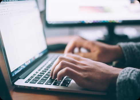 A person typing on a laptop.